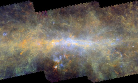 The center of our Milky Way Galaxy, about 25,000 light-years away. Clouds of gas and dust appear distributed along a giant, twisted ring, over 600 light-years wide, which encompasses the supermassive black hole sitting at the Galaxy’s core. Image credit: ESA / Herschel / PACS / SPIRE / Hi-GAL Project / G. Li Causi, IAPS / INAF.