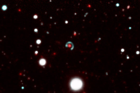 Canarias Einstein ring: the central lensing galaxy is shown in red and the blue Einstein ring is visible all around it. Image credit: M. Bettinelli et al / DECam / CTIO.