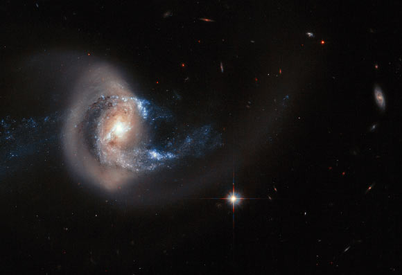 A Hubble image of the spiral galaxy NGC 7714, which has been dramatically distorted in shape by a close interaction with another nearby galaxy. Minor, but frequent, disturbances such as this cause a burst of star formation, accounting for around half of all new stars being formed in the local Universe. Image credit: NASA / ESA / A. Gal-Yam, Weizmann Institute of Science.