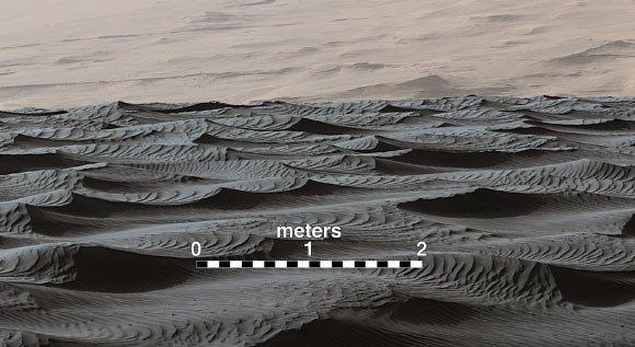 Two sizes of ripples are evident in this December 13, 2015, view of a top of a Martian sand dune, from Curiosity. Sand dunes and the smaller type of ripples also exist on Earth. The larger ripples -- roughly 10 feet (3 m) apart -- are a type not seen on our planet nor previously recognized as a distinct type on Mars. Scale bar - 2 m (79 inches). Image credit: NASA / JPL-Caltech / MSSS.