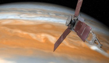 This artist’s rendering shows Juno making one of its close passes over Jupiter. Image credit: NASA / JPL-Caltech.