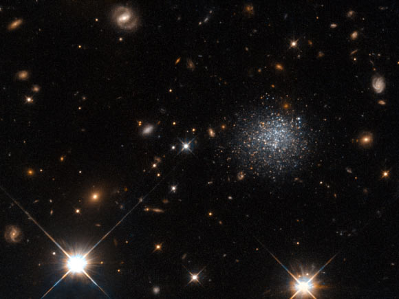 LEDA 677373 among foreground stars and background galaxies. Image credit: NASA / ESA / Hubble.
