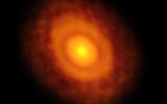 This image of the protoplanetary disc around the young star V883 Orionis was obtained by ALMA in long-baseline mode. The dark ring midway through the disc is the water snow-line, the point from the star where the temperature and pressure dip low enough for water ice to form. Image credit: ALMA / ESO / NAOJ / NRAO / L. Cieza.
