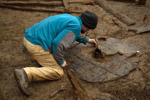 Bronze Age wheel at Must Farm, one meter in diameter, with hub clearly visible. Image credit: Dave Webb / Cambridge Archaeological Unit.