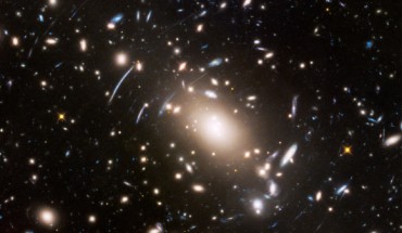 In the center of this Hubble image is the immense galaxy cluster Abell S1063, located 4 billion light-years away, and surrounded by magnified images of galaxies much farther. Image credit: NASA / ESA / J. Lotz, STScI.