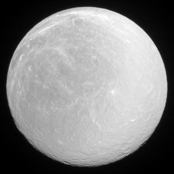 Water ice on Rhea’s surface makes it bright in full sunlight. North on Rhea is up and rotated 36 degrees to the right. Image credit: NASA / JPL-Caltech / Space Science Institute.