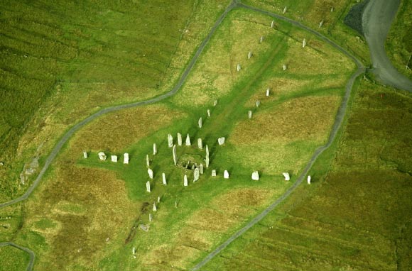 Callanish on the Isle of Lewis is 43 feet (13 m) in diameter with a long stone avenue running north-southwards (southwards is towards the circle) and single long stone rows radiating outwards towards the other three cardinal points. Image credit: Gail Higginbottom & Roger Clay / RCAHMS.