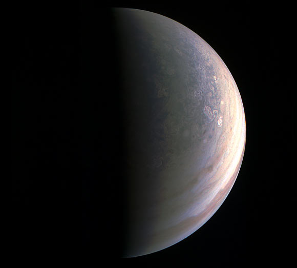 As Juno closed in on Jupiter for the first flyby, its view grew sharper and fine details in the north polar region became increasingly visible. JunoCam obtained this view on August 27, about two hours before closest approach, when the spacecraft was 120,000 miles (195,000 km) away from the gas giant. Unlike the equatorial region’s familiar structure of belts and zones, the poles are mottled with rotating storms of various sizes, similar to giant versions of terrestrial hurricanes. Jupiter’s poles have not been seen from this perspective since NASA’s Pioneer 11 spacecraft flew by the planet in 1974. Image credit: NASA / JPL-Caltech / SwRI / MSSS.