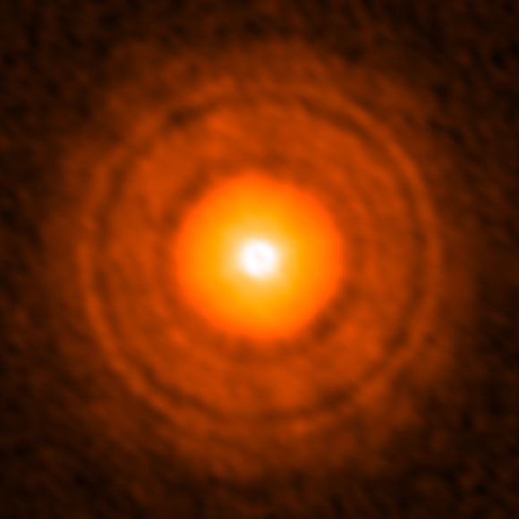 ALMA image of the disk around TW Hydrae. Several gaps are clearly depicted. Astronomers found that the size of the dust particles in the inner 22 AU gap is smaller than in the other bright regions and guess that a Neptune-like planet is located in this gap. Image credit: ALMA / ESO / NAOJ / NRAO / Takashi Tsukagoshi et al.