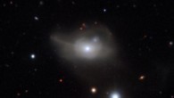 This image from ESO’s Very Large Telescope shows Markarian 1018, a galaxy located approximately 607 million light-years away. The faint loops of light around the galaxy are a result of its interaction and merger with another galaxy in the recent past. Image credit: CARS Survey / ESO.