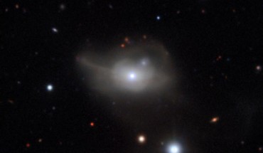This image from ESO’s Very Large Telescope shows Markarian 1018, a galaxy located approximately 607 million light-years away. The faint loops of light around the galaxy are a result of its interaction and merger with another galaxy in the recent past. Image credit: CARS Survey / ESO.