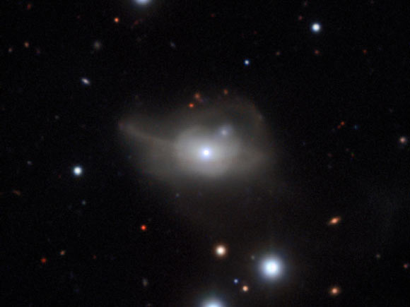 This image from ESO’s Very Large Telescope shows Markarian 1018, a galaxy located approximately 607 million light-years away. The faint loops of light around the galaxy are a result of its interaction and merger with another galaxy in the recent past. Image credit: CARS Survey / ESO.