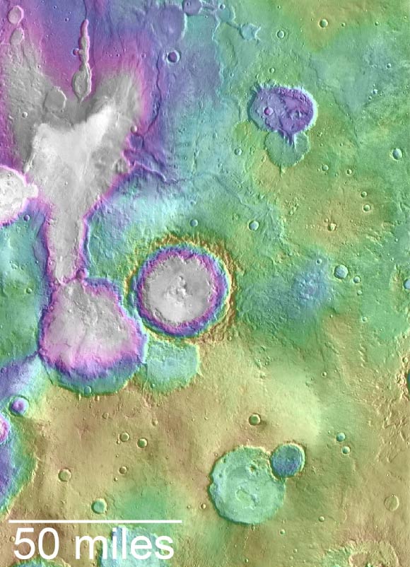 Valleys younger than better-known ancient valley networks on Mars are evident on the landscape in the northern Arabia Terra region, particularly in the area mapped here with color-coded topographical information overlaid onto a photo mosaic. The area includes a basin informally named ‘Heart Lake’ at upper left. Data from NASA’s Mars Global Surveyor orbiter are coded here as white and purple for lower elevations, yellow for higher elevation. The elevation information is combined with a mosaic of images from NASA’s Mars Odyssey orbiter, covering an area about 120 miles (about 190 km) wide. The mapped area is centered near 35.91 degrees north latitude, 1 degree east longitude on Mars. Image credit: NASA / JPL-Caltech / ASU.