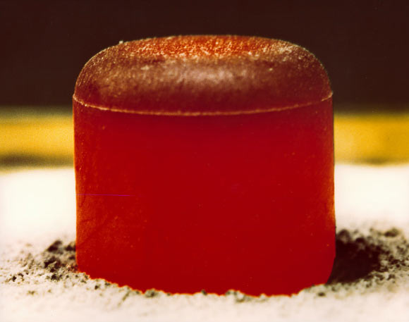 This image shows a pellet of plutonium-238 dioxide. The pellet is glowing red because of the heat generated by the radioactive decay (primarily alpha) of the fuel. Such pellets were used in radioisotope thermoelectric generators that powered NASA’s Galilleo and Cassini spacecraft on missions to Jupiter and Saturn, respectively. Image credit: Los Alamos National Laboratory.
