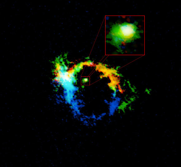 ALMA image of the central region of Messier 77; the torus of material harboring the supermassive black hole is highlighted in the pullout box; this region, which is approximately 40 light-years across, is the result of material flung out of the black hole’s accretion disk; the colors in this image represent the motion of the gas: blue is material moving toward us, red moving away; the areas in green are low velocity and consistent with rotation around a black hole; the white in the central region means the gas is moving both toward and away at very high speed; the outer ring area is unrelated to the black hole and is more tied to the structure of the central 1,000 light-years of the host galaxy. Image credit: ALMA / ESO / NAOJ / NRAO / B. Saxton / AUI / NSF / Gallimore et al.