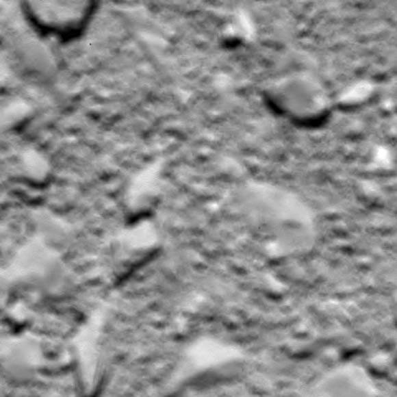This is Rosetta’s last image of Comet 67P/Churyumov-Gerasimenko, taken shortly before impact, an estimated 20 m (66 feet) above the surface. The initially reported 51 m (167 feet) was based on the predicted impact time. Now that this has been confirmed, and following additional information and timeline reconstruction, the estimated distance is now thought to be around 20 m; analysis is ongoing. The image was taken with the OSIRIS wide-angle camera on September 30, 2016. Image credit: ESA / Rosetta / MPS / OSIRIS Team / UPD / LAM / IAA / SSO / INTA / UPM / DASP / IDA.