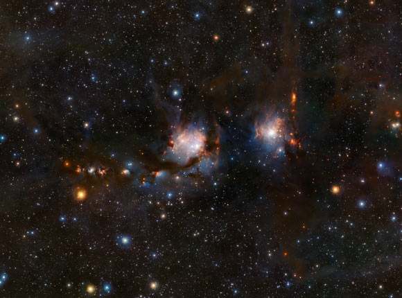 This image of Messier 78 was captured using the VISTA telescope at ESO’s Paranal Observatory. In the image, Messier 78 is the bluish haze in the center, the other reflection nebula towards the right goes by the name of NGC 2071. Image credit: ESO.