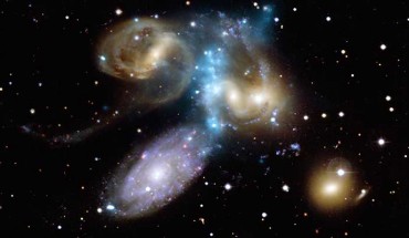 This composite image shows a beautiful new look at the compact group of galaxies known as Stephan’s Quintet. Image credit: X-ray – NASA / CXC / CfA / E. O’Sullivan; optical - Canada-France-Hawaii-Telescope / Coelum.