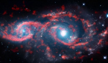 This image, a composite of data from ALMA and the NASA/ESA Hubble Space Telescope, shows a very rare cosmic sight: a pair of interacting galaxies that have taken on an ocular structure. Image credit: ALMA / ESO / NAOJ / NRAO / M. Kaufman.