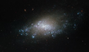 This image, taken with the Wide Field Camera 3 on board the NASA/ESA Hubble Space Telescope, shows NGC 3274, a barred spiral galaxy about 21 million light-years from Earth. The galaxy PGC 213714 is also visible on the upper right of the frame, located much further away from us. Image credit: NASA / ESA / Hubble / D. Calzetti.