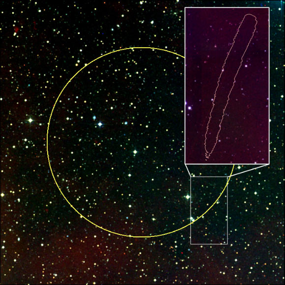 The location of the FRB 150807. The yellow circle shows the typical location of an FRB. There are thousands of stars and galaxies in this direction. Because FRB 150807 was very bright the astronomers were able to locate it to a small region near the edge of that circle, shown as the pink banana-shaped region in the inset. In this region there are only six detected galaxies. The position of the most likely host galaxy, VHS7, is highlighted on the plot. Image credit: Vikram Ravi, California Institute of Technology / Ryan Shannon, ICRAR-Curtin & CSIRO.