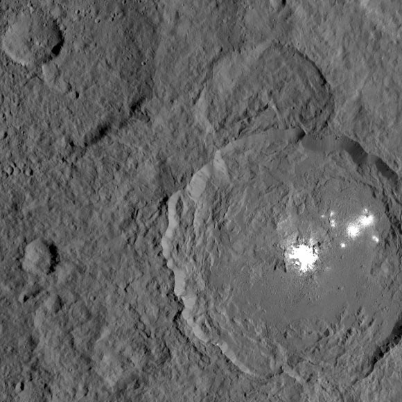 This image shows Occator Crater, with its signature bright areas. Dawn scientists have found that the central bright spot, which harbors the brightest material on Ceres, contains a variety of salts. The brightest parts of these features are overexposed in this image, which had an exposure time intended to capture details in the surrounding terrain. Dawn took this image on Oct. 18, 2016, at a distance of about 920 miles above the surface. Image credit: NASA / JPL-Caltech / UCLA / MPS / DLR / IDA.