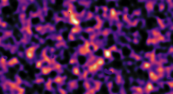 This map of dark matter was obtained from data from the KiDS survey, using ESO’s VLT Survey Telescope. It reveals an expansive web of dense (light) and empty (dark) regions. This image is one out of five patches of the sky observed by KiDS. The invisible dark matter is seen rendered in pink, covering an area of sky around 420 times the size of the full Moon. This image reconstruction was made by analyzing the light collected from over 3 million galaxies more than 6 billion light-years away. The observed galaxy images were warped by the gravitational pull of dark matter as the light traveled through the Universe. Some small dark regions, with sharp boundaries, appear in this image. They are the locations of bright stars and other nearby objects that get in the way of the observations of more distant galaxies and are hence masked out in the map as no weak-lensing signal can be measured in these areas. Image credit: Kilo-Degree Survey Collaboration / H. Hildebrandt & B. Giblin / ESO.