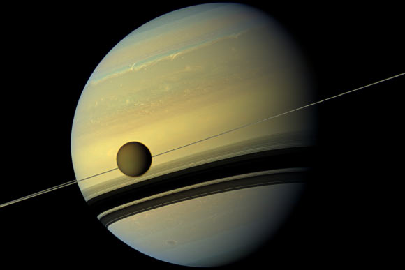 A giant of a moon appears before a giant of a planet undergoing seasonal changes in this natural color view of Titan and Saturn from NASA’s Cassini spacecraft. Image credit: NASA / JPL-Caltech / SSI.