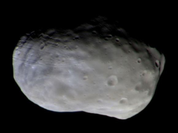 Color composite of Phobos taken with TGO’s CaSSIS camera on November 26, 2016. The observation was made at a distance of 4,785 miles (7,700 km). To create the final color image, two images were taken through each of the four color filters of the camera -- panchromatic, blue-green, red and infrared -- and then stitched together and combined to produce the high-resolution composite. Two of the color filters used by CaSSIS lie outside the wavelength response of the human eye, so this is not a ‘true’ color image. However, showing the data as a color representation can reveal details of the surface mineralogy. Different colors are clearly seen, with the bluest part in the direction of the large crater Stickney, which is out of view over the limb to the left. Although the exact composition of the material is unknown, the color differences are thought to be caused by compositional variations on scales of hundreds of feet to several miles. Image credit: ESA.