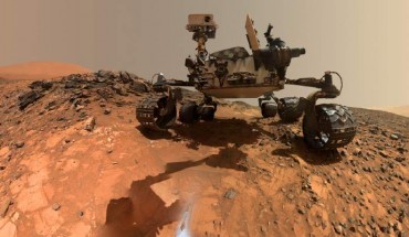 This low-angle self-portrait of NASA’s Curiosity rover shows the vehicle at the site from which it reached down to drill into a rock target called ‘Buckskin’ on lower Mount Sharp. The selfie combines several component images taken by Curiosity’s Mars Hand Lens Imager (MAHLI) on Aug. 5, 2015, during 1065 Sol (Martian day) of the rover’s work on Mars. For scale, the rover’s wheels are 20 inches (50 cm) in diameter and about 16 inches (40 cm) wide. Image credit: NASA / JPL-Caltech / MSSS.