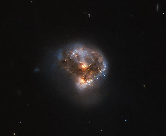 This image shows the megamaser galaxy LEDA 58817, which lies in the constellation Ophiuchus, about 370 million light-years away. Image credit: NASA / ESA / Hubble / Judy Schmidt, www.geckzilla.com.
