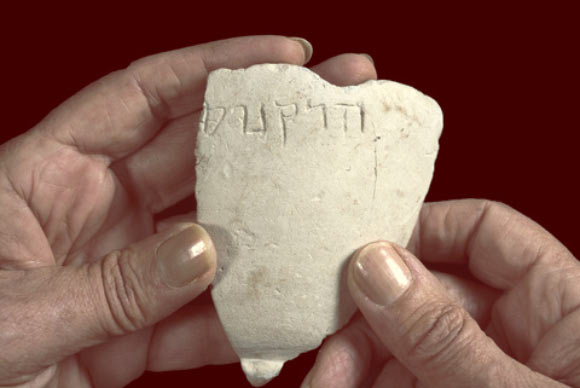 The fragment of the 2,100-year-old stone bowl, which is engraved with the name Hyrcanus. Image credit: Clara Amit / Israel Antiquities Authority.