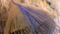 A vast alluvial fan in the XinJiang province of China. The right side is the active part of the fan, and appears blue from water currently flowing in the many small streams. The image was acquired on May 2, 2002. Image credit: NASA / GSFC / METI / ERSDAC / JAROS / US-Japan ASTER Science Team.