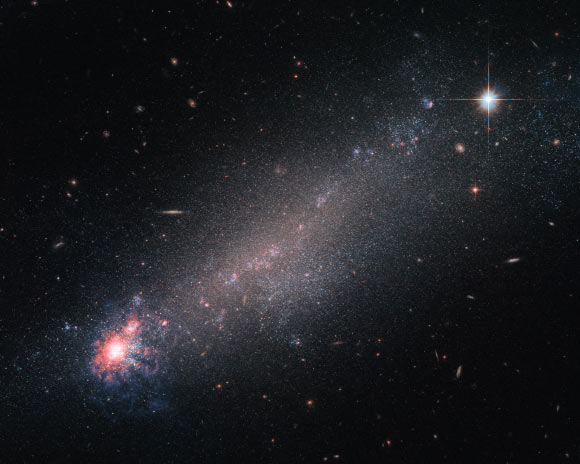This Hubble image shows the cometary dwarf galaxy NGC 4861, which lies in the constellation of Canes Venatici, about 22.8 million light-years away. Image credit: NASA / ESA / Hubble.