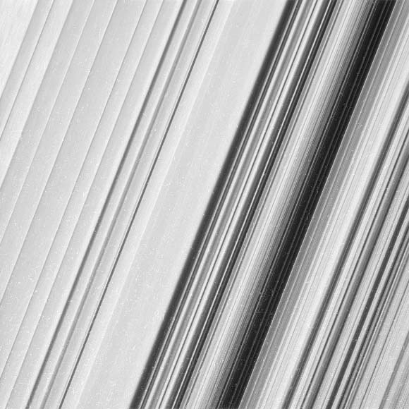 This image shows a region in Saturn’s outer B ring. Cassini viewed this area at a level of detail twice as high as it had ever been observed before. And from this view, it is clear that there are still finer details to uncover. Researchers have yet to determine what generated the rich structure seen in this view, but they hope detailed images like this will help them unravel the mystery. In order to preserve the finest details, this image has not been processed to remove the many small bright blemishes, which are created by cosmic rays and charged particle radiation near the planet. The image was taken in visible light with Cassini’s wide-angle camera on December 18, 2016. The view was obtained at a distance of approximately 32,000 miles (51,000 km) from the rings, and looks toward the unilluminated side of the rings. Image credit: NASA / JPL-Caltech / Space Science Institute.