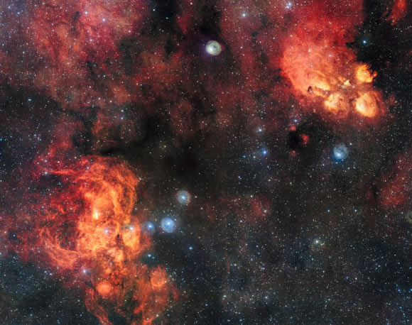 This spectacular image from ESO’s VLT Survey Telescope shows the Cat’s Paw Nebula (upper right) and the Lobster Nebula (lower left); these dramatic objects are regions of active star formation where the hot young stars are causing the surrounding hydrogen gas to glow red; the very rich field of view also includes dark clouds of dust; with around two billion pixels this is one of the largest images ever released by ESO. Image credit: ESO.