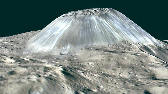 Ahuna Mons, Ceres’ lonely mountain, is seen in this simulated perspective view. The elevation has been exaggerated by a factor of two. The view was made using enhanced-color images from NASA’s Dawn orbiter. Images taken using blue (440 nm), green (750 nm) and infrared (960 nm) spectral filters were combined to create the view. The spacecraft’s framing camera took the images from Dawn’s low-altitude mapping orbit, from an altitude of 240 miles (385 km) in August 2016. Image credit: NASA / JPL-Caltech / UCLA / MPS / DLR / IDA / PSI.