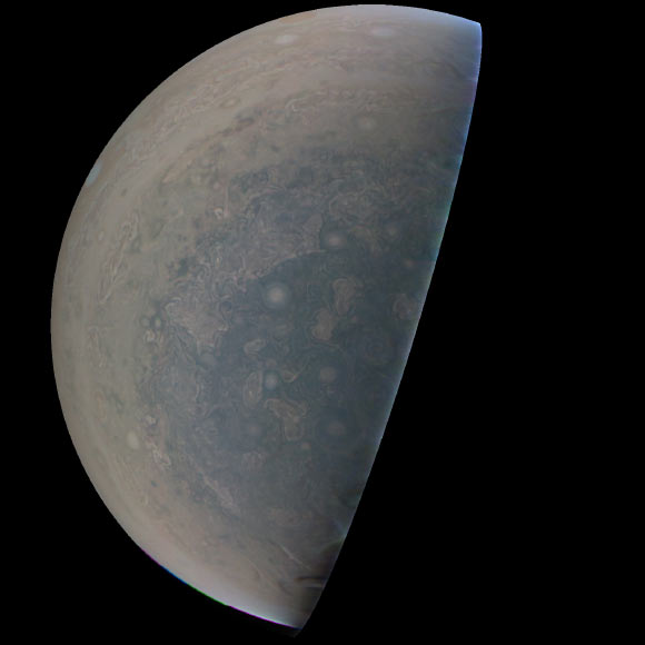 Cyclones swirl around the south pole, and white oval storms can be seen near the limb -- the apparent edge of the planet -- in this image of Jupiter’s south polar region taken by the JunoCam imager aboard NASA’s Juno spacecraft. The image was acquired on February 2, 2017, from an altitude of 47,600 miles (76,600 km) above Jupiter’s swirling cloud deck. Prior to the Feb. 2 flyby, the public was invited to vote for their favorite points of interest in the Jovian atmosphere for JunoCam to image. The point of interest captured here was titled ‘Jovian Antarctica’ by a member of the public, in reference to Earth’s Antarctica. Image credit: NASA / JPL-Caltech / SwRI / MSSS.