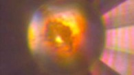 Microphotograph of the diamond anvil cell high-pressure cavity in reflected and transmitted light at 140 GPa after laser heating to > 1,500 degrees Kelvin. The sample, which consists of mixture of tI19 Na and Na2He, is in contact with He medium that is seen as a transparent area near the edge of the gasket. Image credit: Xiao Dong et al, doi: 10.1038/nchem.2716.