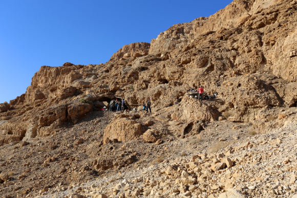 Fault cliff and entrance to Cave 12. Image credit: Casey L. Olson / Oren Gutfeld.