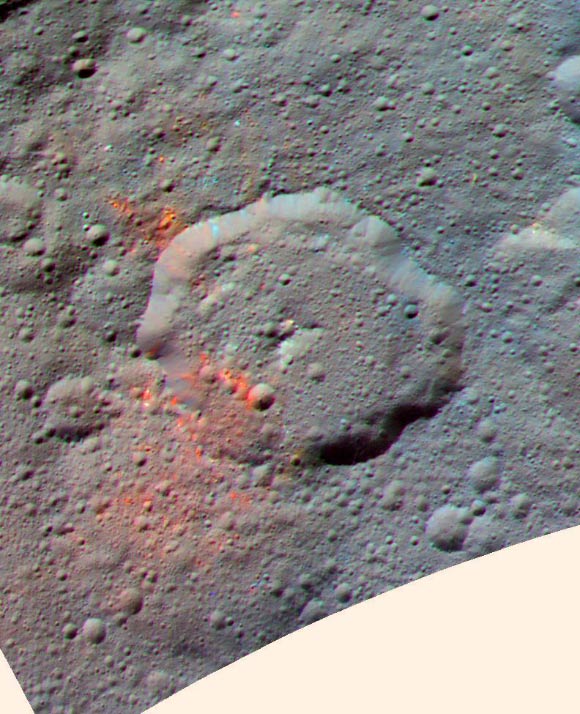 This enhanced color composite image, made with data from NASA’s Dawn spacecraft, shows the area around Ernutet crater, which is about 32 miles (52 km) in diameter and is located in the northern hemisphere. The bright red portions appear redder with respect to the rest of Ceres. In the new study, planetary researchers found that these red areas around Ernutet are associated with evidence of organic material. Images taken using blue (440 nm), green (750 nm) and infrared (960 nm) spectral filters were combined to create the view. Image credit: NASA / JPL-Caltech / UCLA / MPS / DLR / IDA.