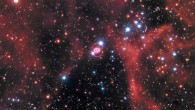 This Hubble image shows the remnant of SN 1987A within the Large Magellanic Cloud, a satellite galaxy of the Milky Way. The image was taken by Hubble’s Wide Field Camera 3 (WFC3) in January 2017. SN 1987A is located in the center of the image amidst a backdrop of stars. The bright ring around the central region of the exploded star is composed of material ejected by the star about 20,000 years before the actual explosion took place. The supernova is surrounded by gaseous clouds. The clouds’ red color represents the glow of hydrogen gas. The colors of the foreground and background stars were added from observations taken by Hubble’s Wide Field Planetary Camera 2 (WFPC2). Image credit: NASA / ESA / R. Kirshner, Harvard-Smithsonian Center for Astrophysics and Gordon and Betty Moore Foundation / P. Challis, Harvard-Smithsonian Center for Astrophysics.