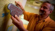 Pro.f Braswell holds a replica of the Maya jade pendant. Image credit: Erik Jepsen, University of California, San Diego Publications.