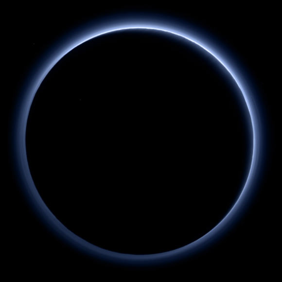 Pluto’s haze layer shows its blue color in this picture taken by the New Horizons Ralph/Multispectral Visible Imaging Camera (MVIC). The high-altitude haze is thought to be similar in nature to that seen at Saturn’s moon Titan. The source of both hazes likely involves sunlight-initiated chemical reactions of nitrogen and methane, leading to relatively small, soot-like particles -- called tholins -- that grow as they settle toward the surface. This image was generated by software that combines information from blue, red and near-infrared images to replicate the color a human eye would perceive as closely as possible. Image credit: NASA / Johns Hopkins University Applied Physics Laboratory / Southwest Research Institute.