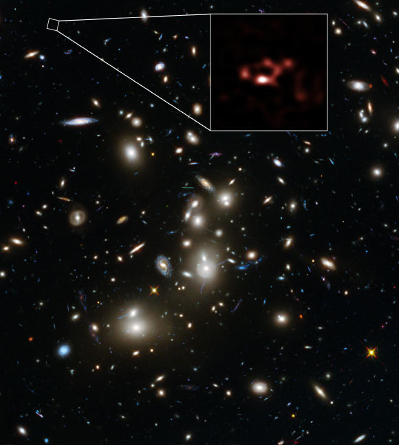 This image is dominated by a spectacular view of the rich galaxy cluster Abell 2744 from the NASA/ESA Hubble Space Telescope. But, far beyond this cluster, and seen when the Universe was only about 600 million years old, is the young galaxy A2744_YD4. New observations of this galaxy with ALMA, shown in red, have demonstrated that it is rich in dust. Image credit: ALMA / ESO / NAOJ / NRAO / NASA / ESA / D. Coe, STScI / J. Merten, Heidelberg & Bologna.