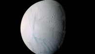 This enhanced-color view of Enceladus is largely of the southern hemisphere and includes the south polar terrain at the bottom of the image. Ancient craters remain somewhat pristine in some locales, but have clearly relaxed in others. Northward-trending fractures, likely caused by a change in the moon’s rate of rotation and the consequent flattening of the moon’s shape, rip across the southern hemisphere. The south polar terrain is marked by a striking set of ‘blue’ fractures and encircled by a conspicuous and continuous chain of folds and ridges, testament to the forces within Enceladus that have yet to be silenced. The mosaic was created from 21 false-color frames taken during Cassini’s close approaches to Enceladus on March 9 and July 14, 2005. Images taken using filters sensitive to UV, visible and IR light (spanning wavelengths from 338 to 930 nm) were combined to create the individual frames. Image credit: NASA / JPL / Space Science Institute.