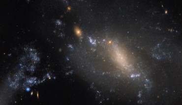 This Hubble image captures an ongoing cosmic collision between two galaxies: NGC 3447A and NGC 3447B. Image credit: NASA / ESA / Hubble.