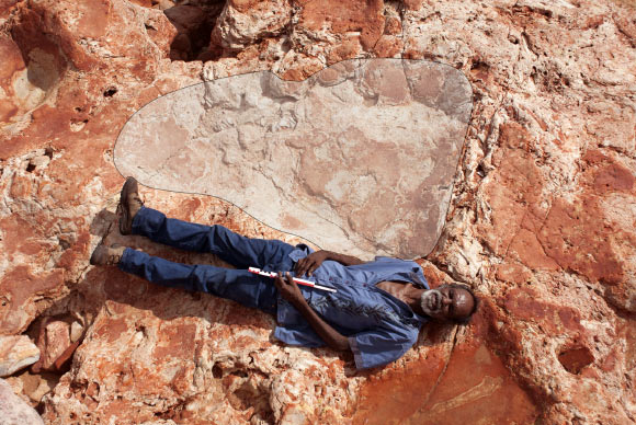 Goolarabooloo Law Boss Richard Hunter with a giant sauropod track in the Dampier Peninsula, Western Australia. Image credit: Steve Salisbury.