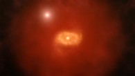 This is an artist impression of a progenitor of Milky Way-like galaxies in the early Universe with a background quasar shining through a ‘super halo’ of hydrogen gas surrounding the galaxy. New ALMA observations of two such galaxies reveal that these vast halos extend well beyond the galaxies’ dusty, star-forming disks. Image credit: A. Angelich / NRAO / AUI / NSF.