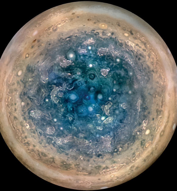 This image shows Jupiter’s south pole, as seen by NASA’s Juno spacecraft from an altitude of 32,000 miles (52,000 km). The oval features are cyclones, up to 600 miles (1,000 km) in diameter. Multiple images taken with the JunoCam instrument on three separate orbits were combined to show all areas in daylight, enhanced color, and stereographic projection. Image credit: NASA / JPL-Caltech/ Southwest Research Institute / MSSS / Betsy Asher Hall / Gervasio Robles.